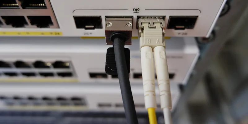 Z prawej zainstalowany moduł SFP z dopiętym patch cordem światłowodem, z lewej włożony kabel DAC (opisany niżej w materiałach)
